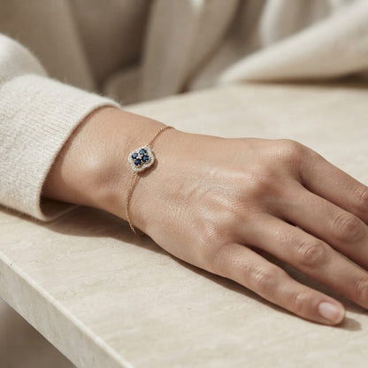 18K yellow gold bracelet with round blue sapphire cluster surrounded by round brilliant diamonds