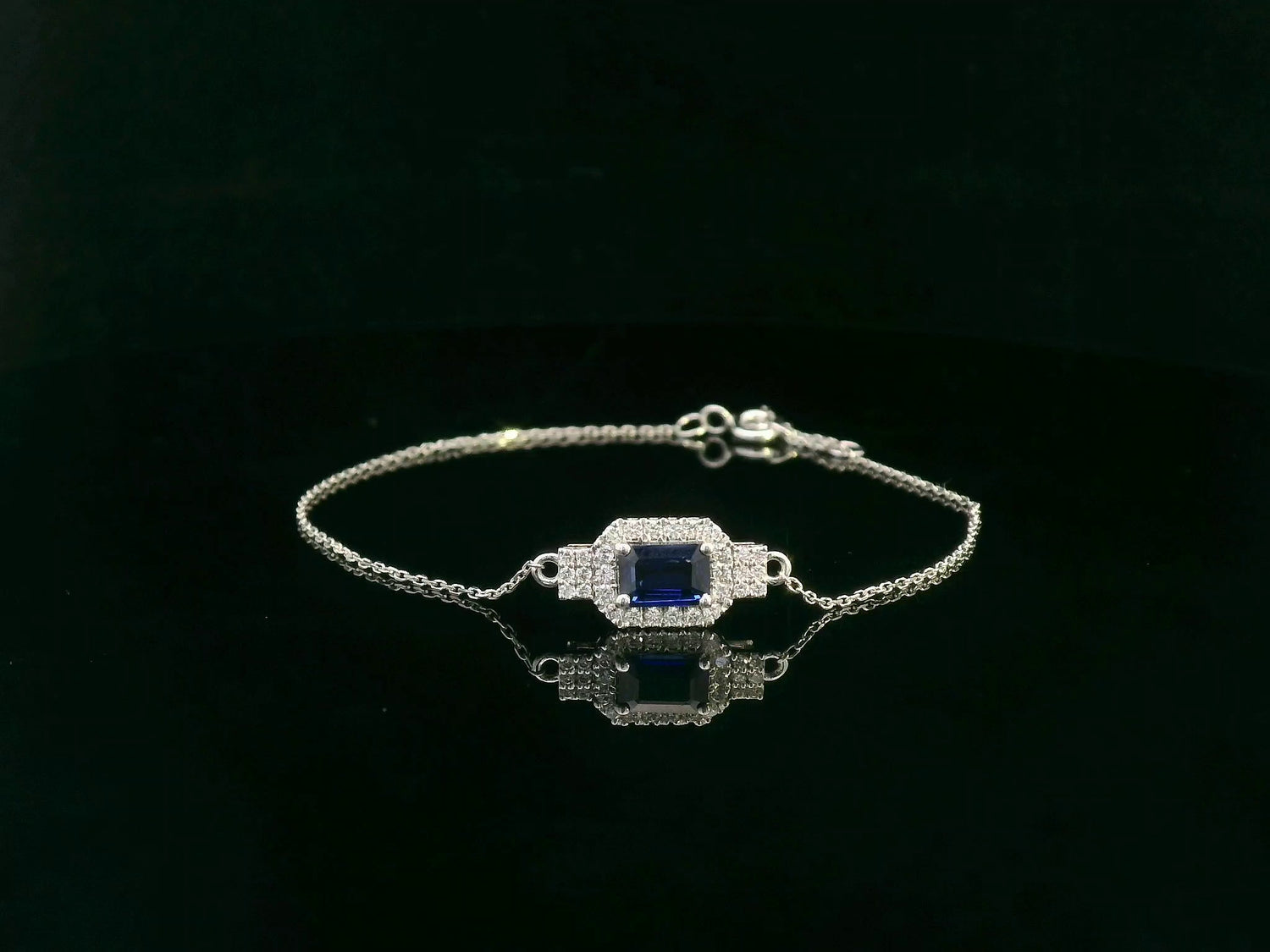 18K white gold sapphire halo bracelet with emerald-cut 0.80ct blue sapphire and diamond accents – Emirates Diamonds.