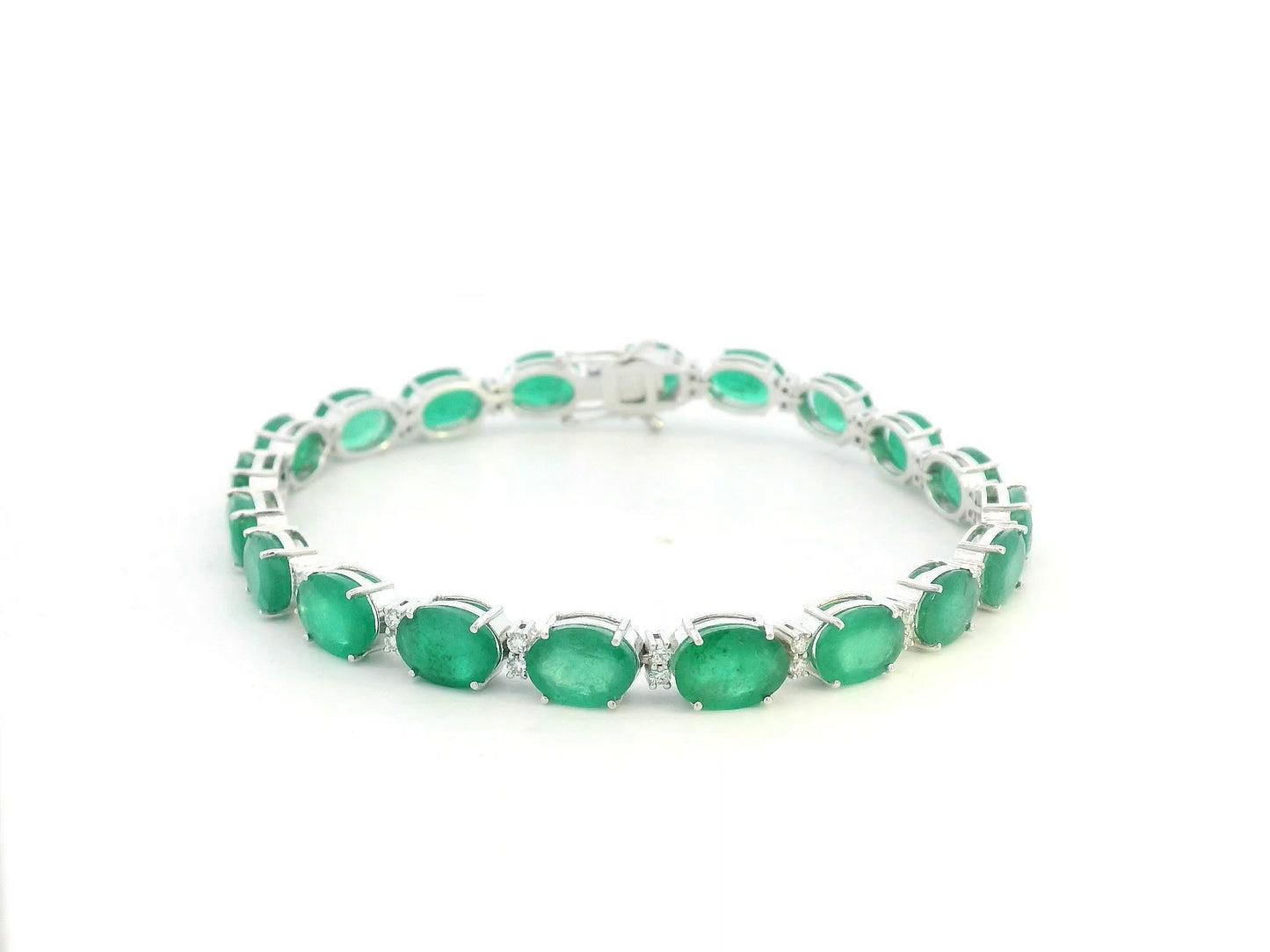 18K white gold emerald and diamond tennis bracelet with oval-cut emeralds, 23.29 carat emeralds by Emirates Diamonds
