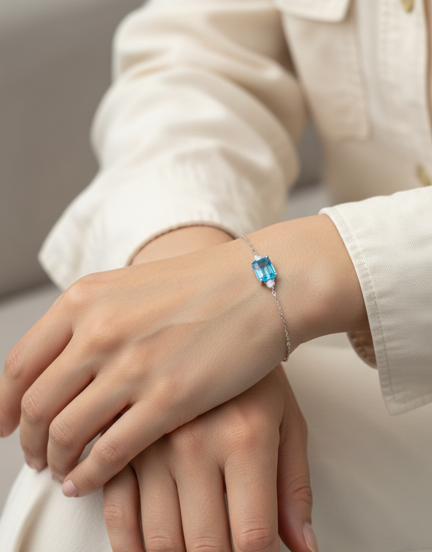 18K white gold Swiss blue topaz bracelet with emerald-cut center stone and diamond accents – Emirates Diamonds