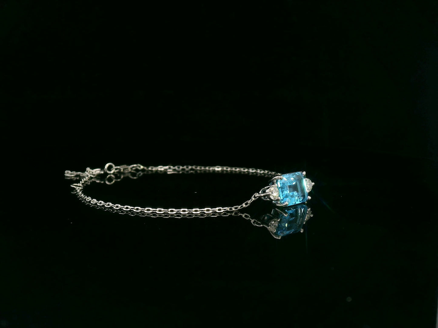18K white gold Swiss blue topaz bracelet with emerald-cut center stone and diamond accents – Emirates Diamonds