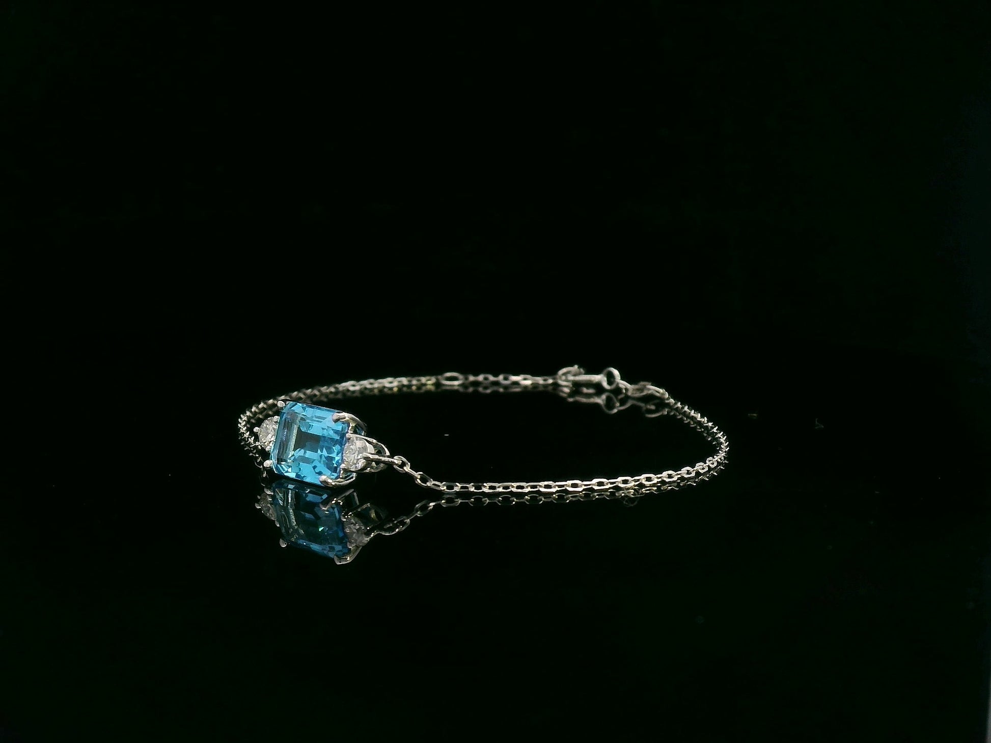 18K white gold Swiss blue topaz bracelet with emerald-cut center stone and diamond accents – Emirates Diamonds