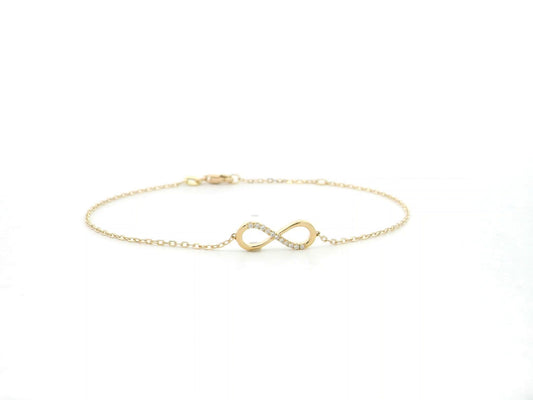 Diamond infinity bracelet in 18K yellow gold with 0.05 carat natural diamonds by Emirates Diamonds.