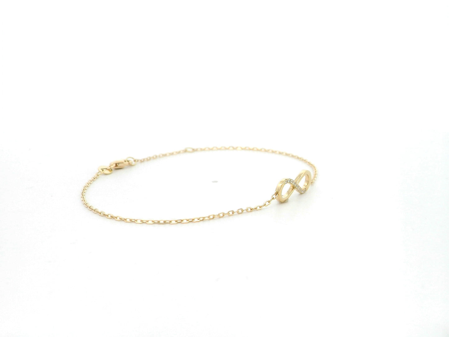 Diamond infinity bracelet in 18K yellow gold with 0.05 carat natural diamonds by Emirates Diamonds.