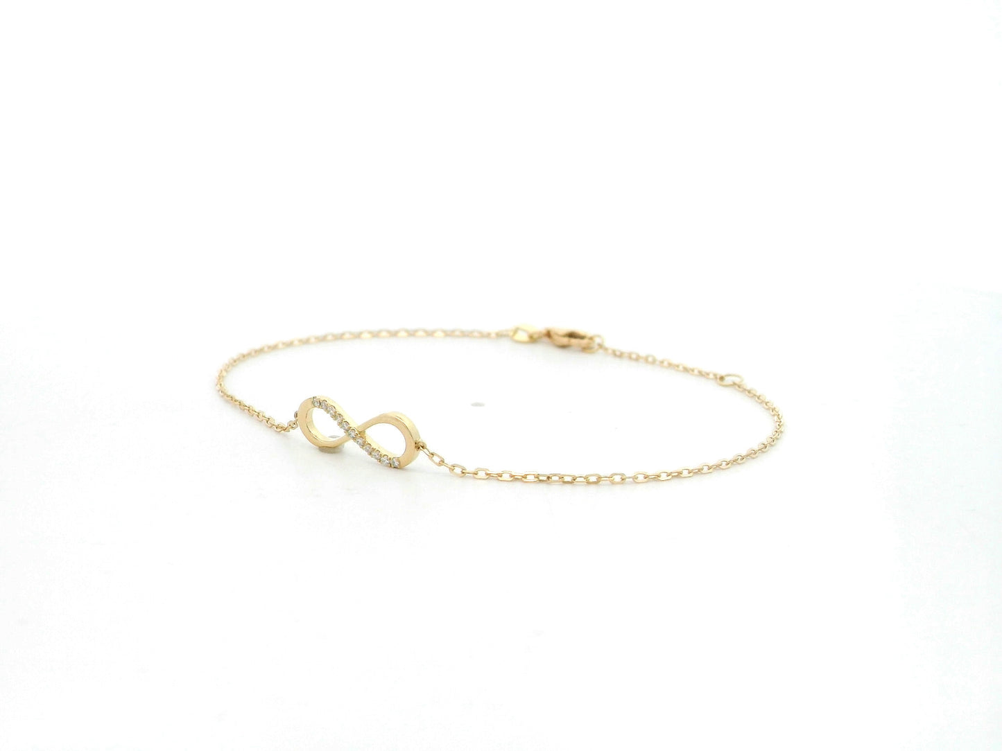 Diamond infinity bracelet in 18K yellow gold with 0.05 carat natural diamonds by Emirates Diamonds.