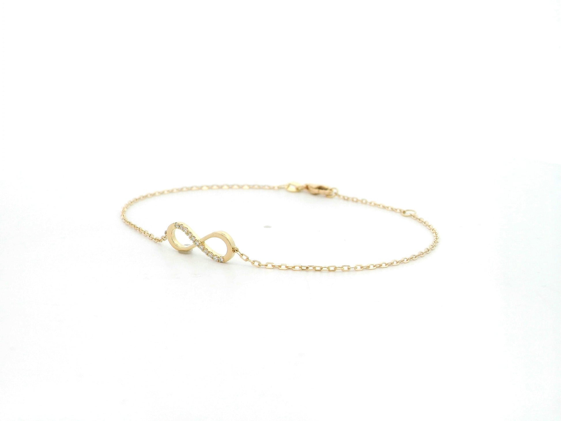 Diamond infinity bracelet in 18K yellow gold with 0.05 carat natural diamonds by Emirates Diamonds.