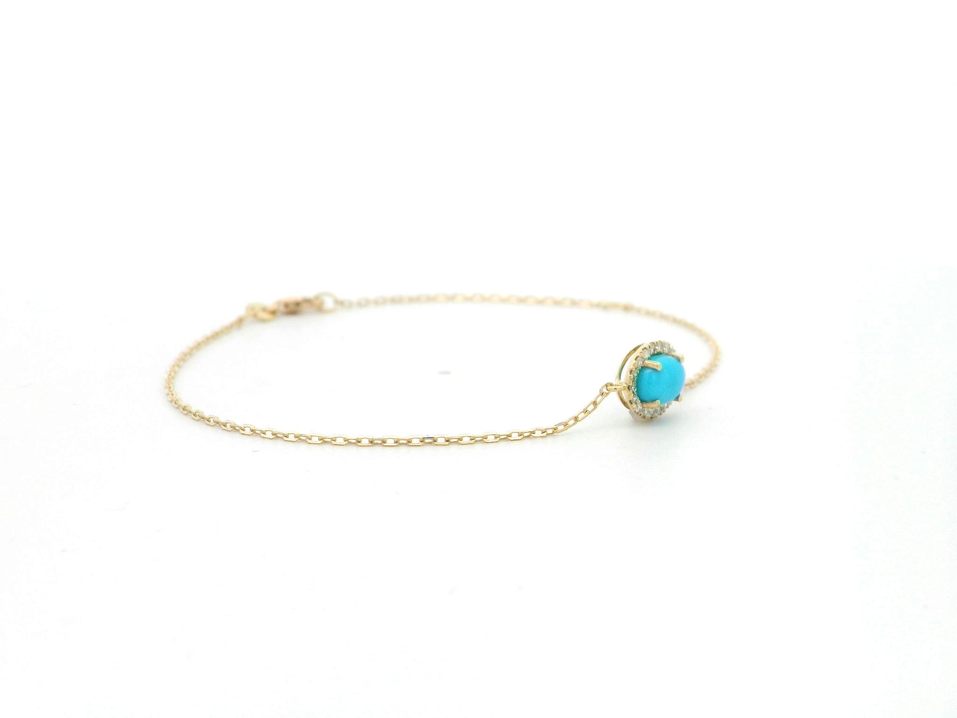 Turquoise diamond halo bracelet in 18K yellow gold with delicate chain by Emirates Diamonds