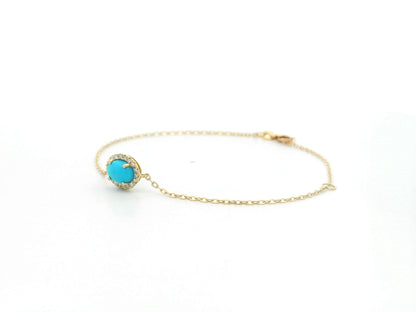 Turquoise diamond halo bracelet in 18K yellow gold with delicate chain by Emirates Diamonds