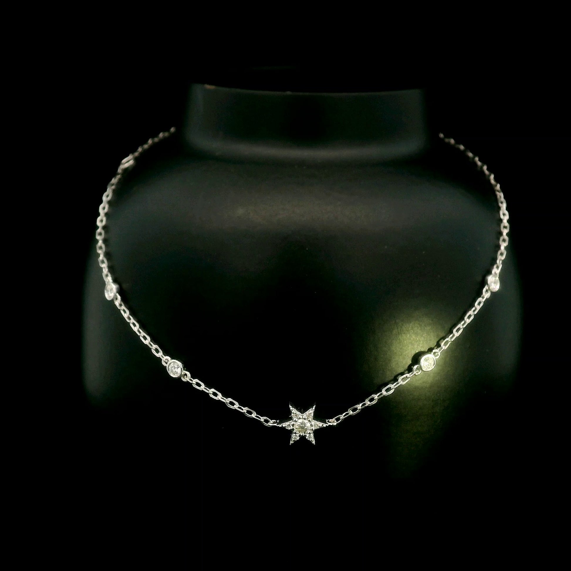 Diamond chain bracelet in 18K white gold featuring a pavé diamond star motif with bezel-set station diamonds totalling 0.16 carat.