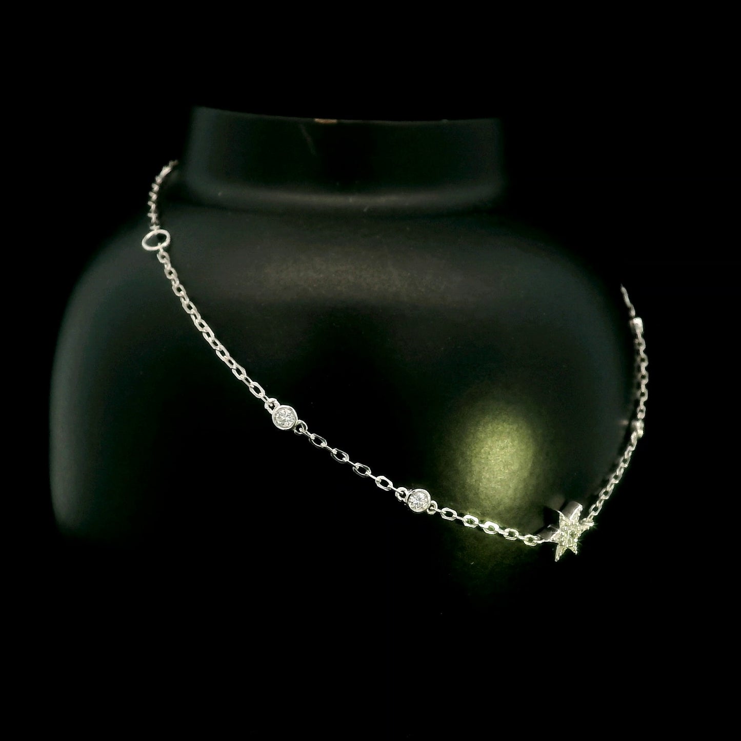 Diamond chain bracelet in 18K white gold featuring a pavé diamond star motif with bezel-set station diamonds totalling 0.16 carat.
