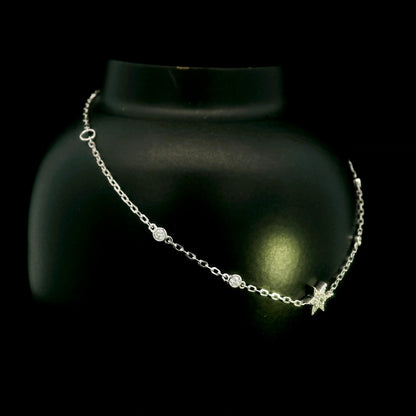 Diamond chain bracelet in 18K white gold featuring a pavé diamond star motif with bezel-set station diamonds totalling 0.16 carat.