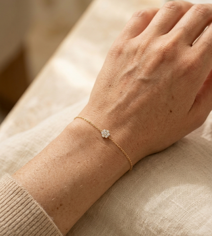 18K yellow gold diamond flower bracelet featuring a natural diamond floral motif on a delicate chain.