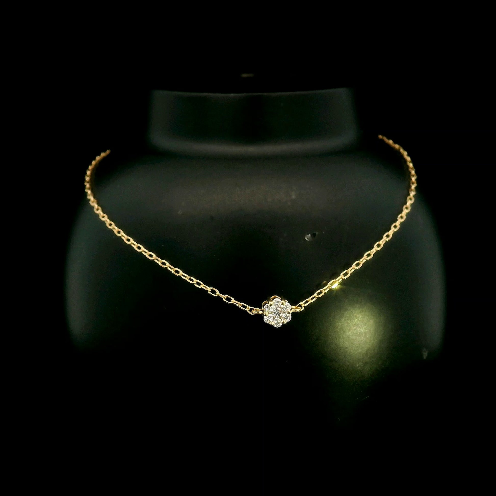 18K yellow gold diamond flower bracelet featuring a natural diamond floral motif on a delicate chain.