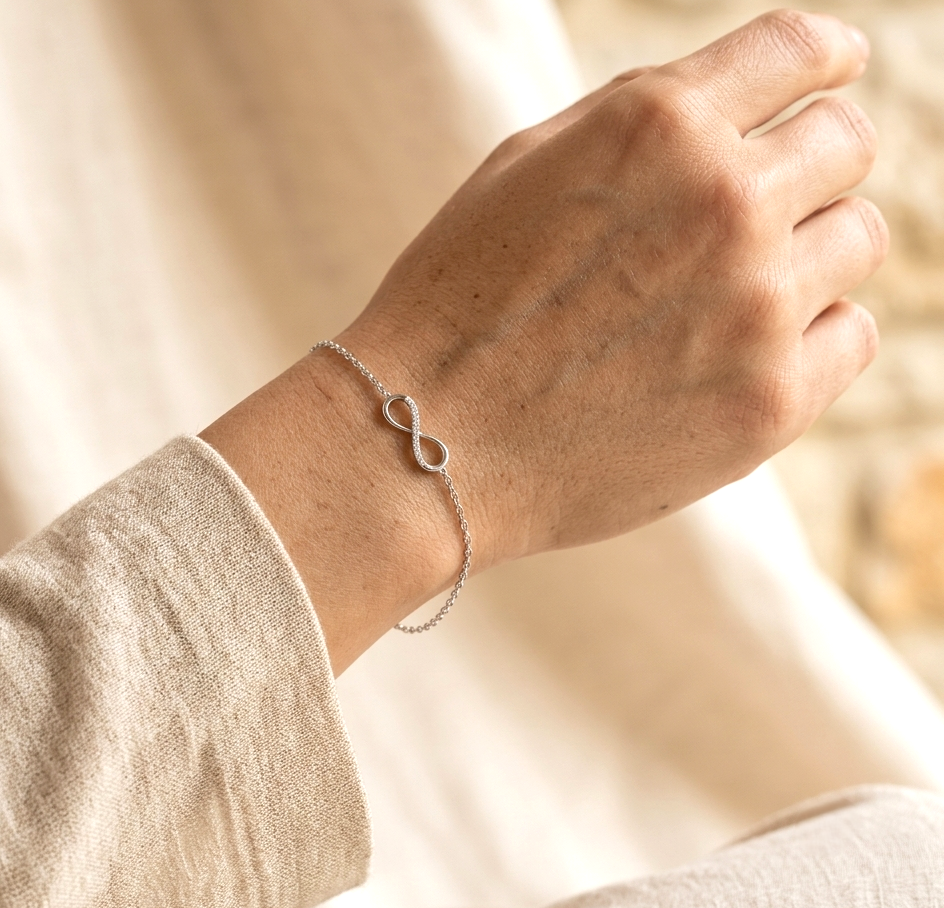 Diamond infinity bracelet in 18K White Gold featuring a pavé-set infinity motif with 0.05 carat natural diamonds.