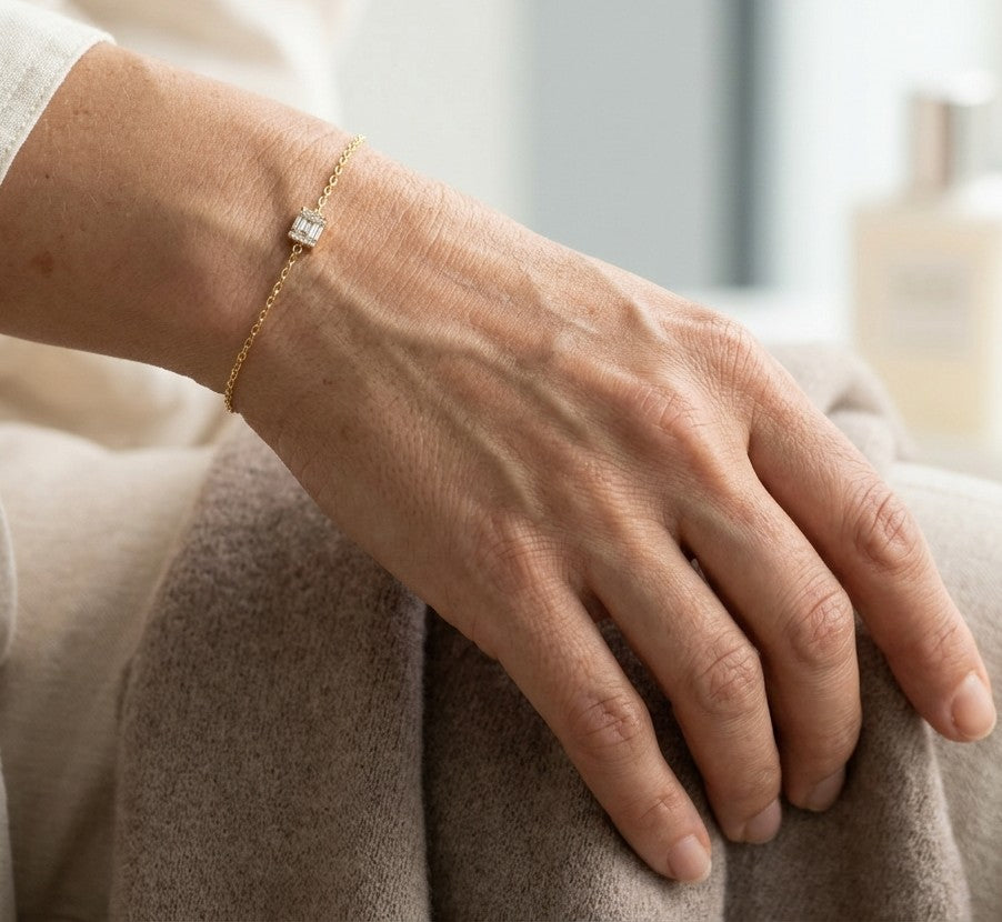 18K yellow gold bracelet with baguette and round natural diamonds in a geometric centre design on a fine adjustable chain