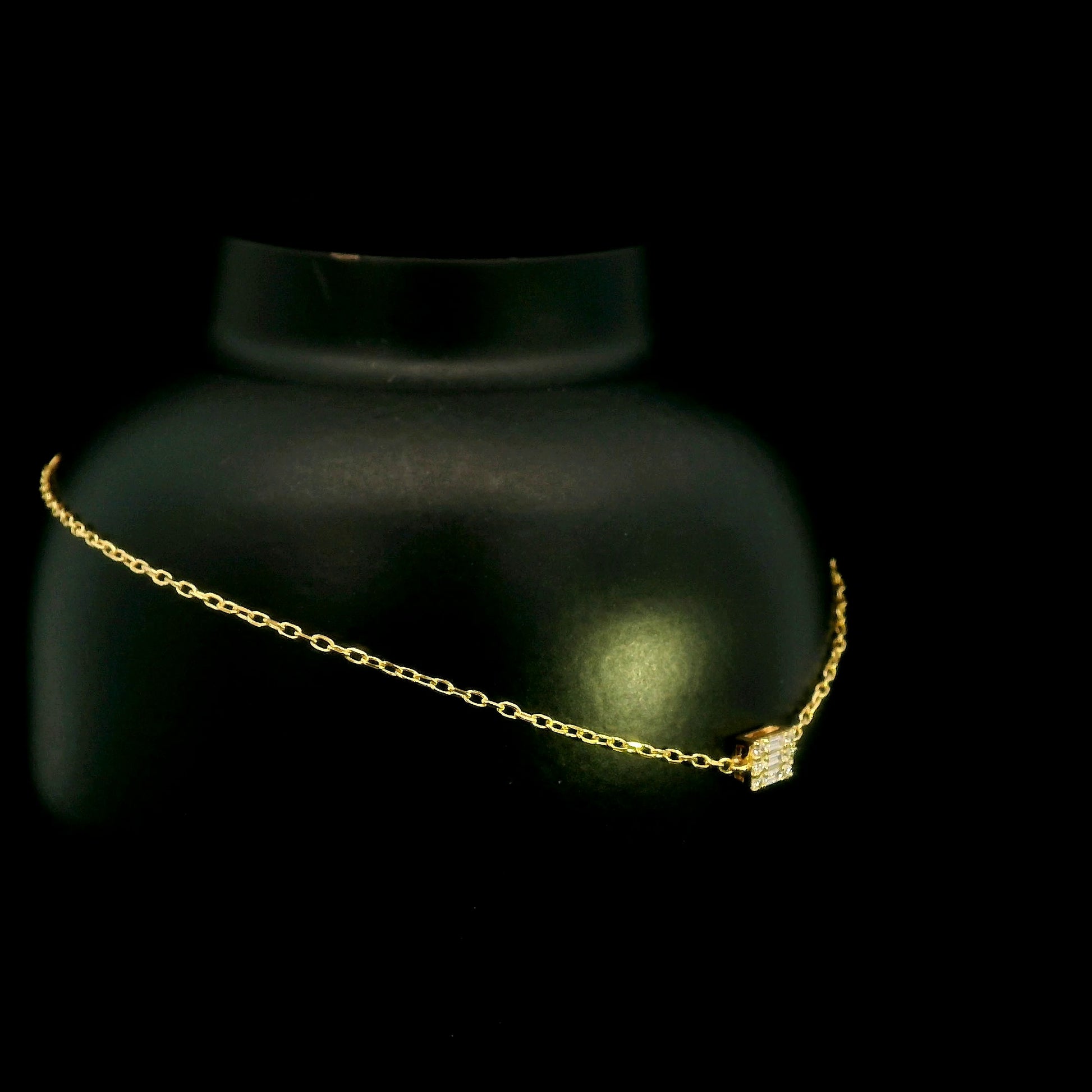 18K yellow gold bracelet with baguette and round natural diamonds in a geometric centre design on a fine adjustable chain