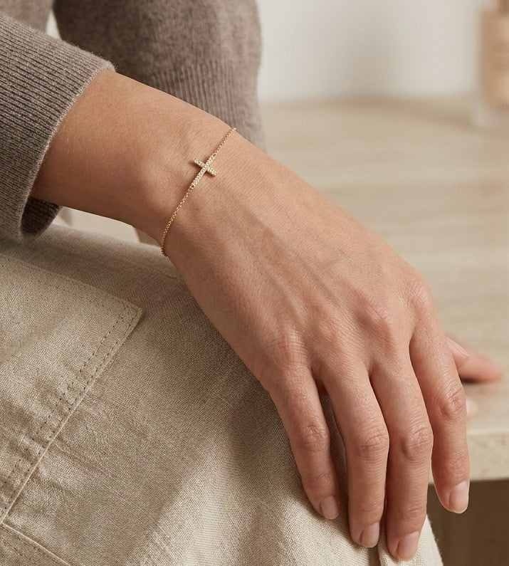 18K yellow gold sideways diamond cross bracelet with round natural diamonds and adjustable fine gold chain