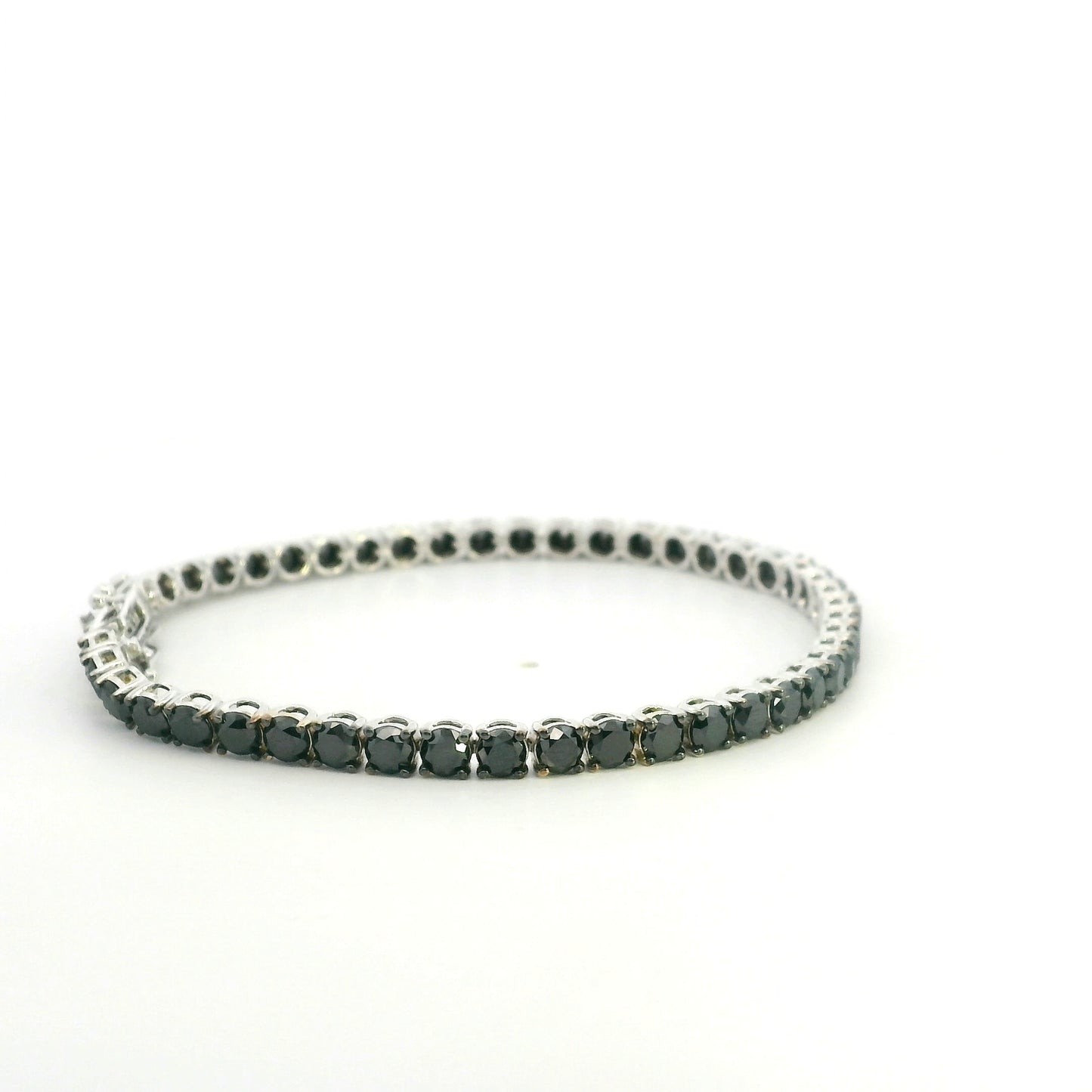 18K white gold black diamond tennis bracelet featuring a continuous row of round natural black diamonds totaling 8.38 carats