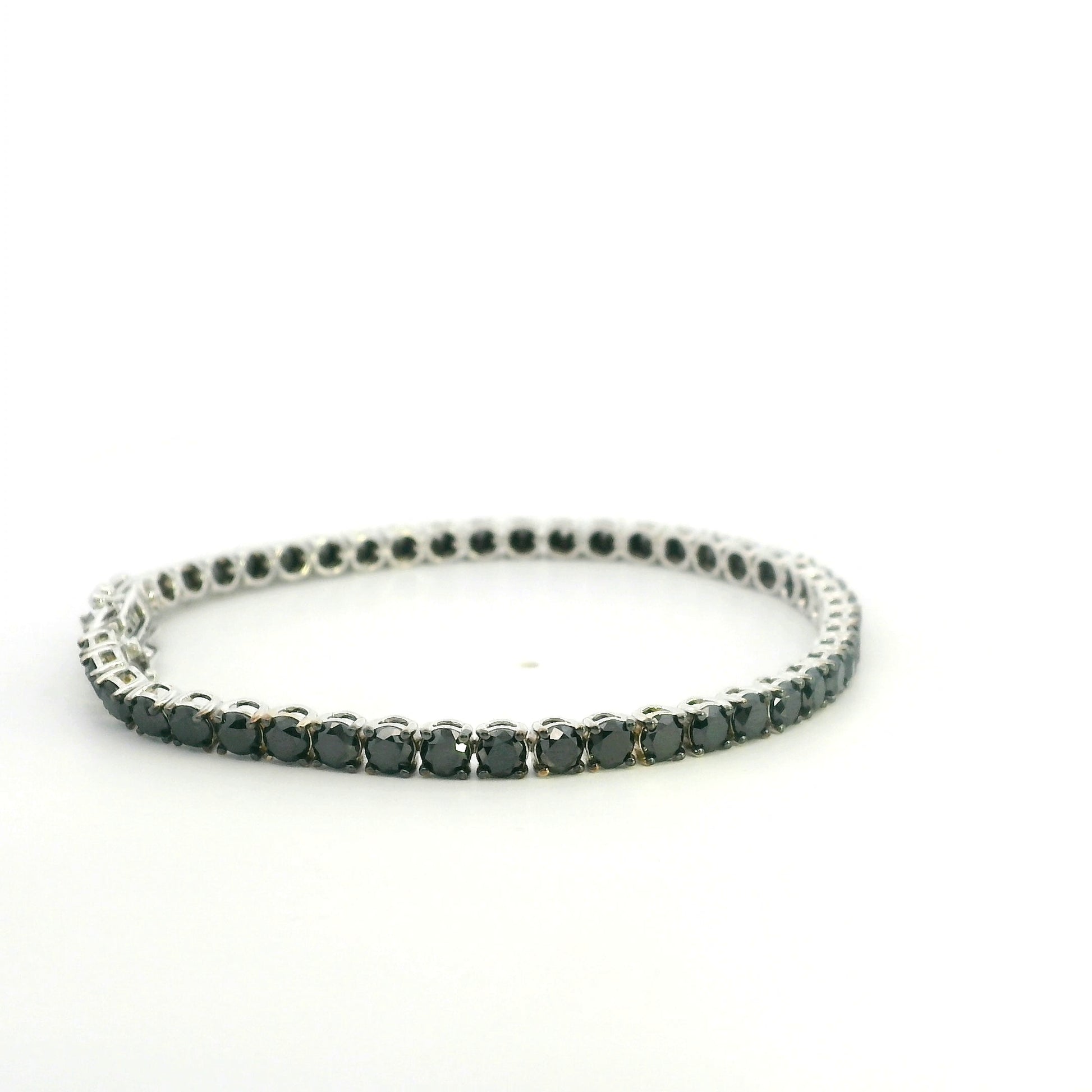 18K white gold black diamond tennis bracelet featuring a continuous row of round natural black diamonds totaling 8.38 carats