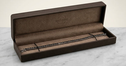 Black diamond tennis bracelet in 18K white gold with a continuous single row of round black diamonds