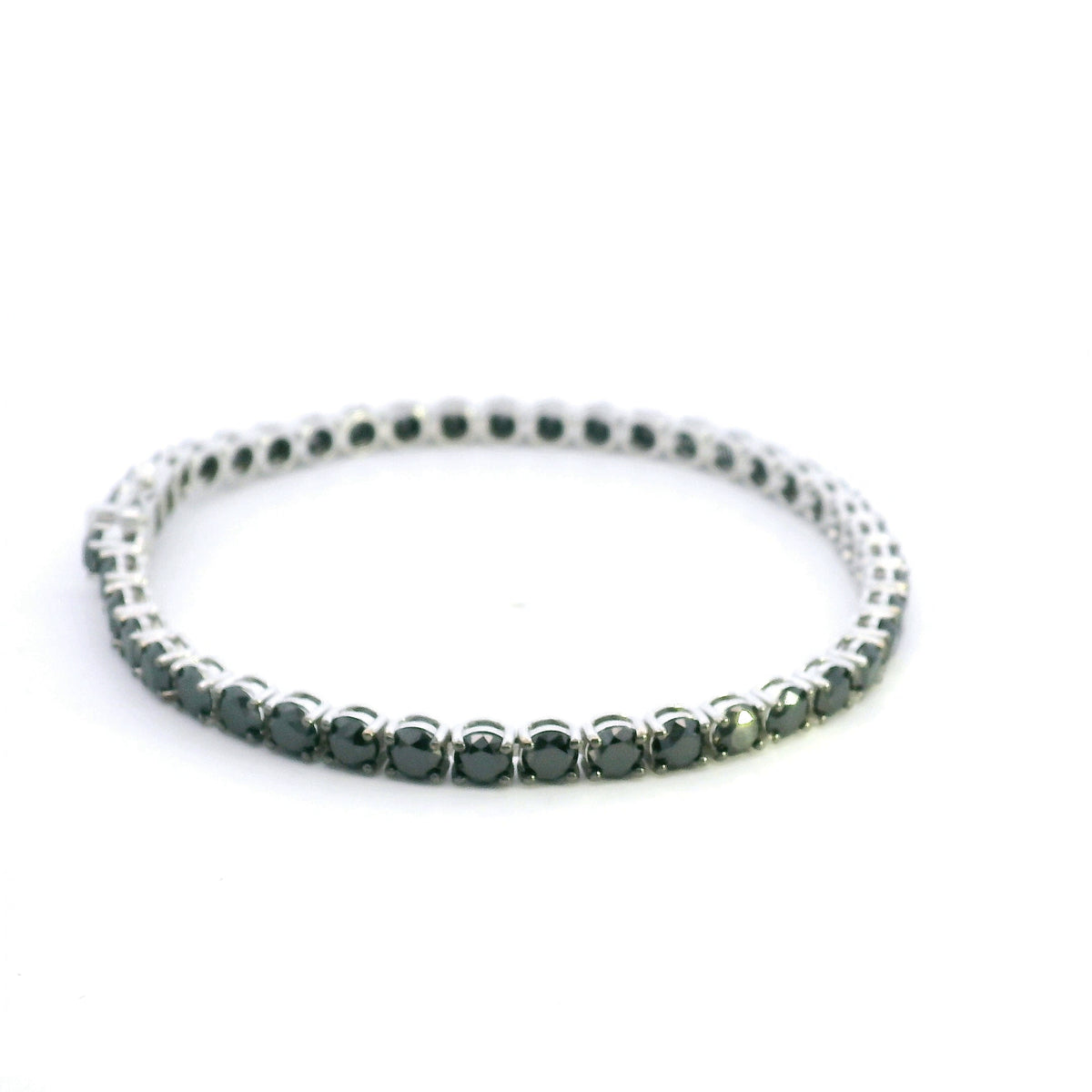 Black diamond tennis bracelet in 18K white gold with a continuous single row of round black diamonds