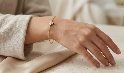 18K yellow gold diamond cluster bracelet featuring three round diamonds in a central prong setting on a delicate gold chain.