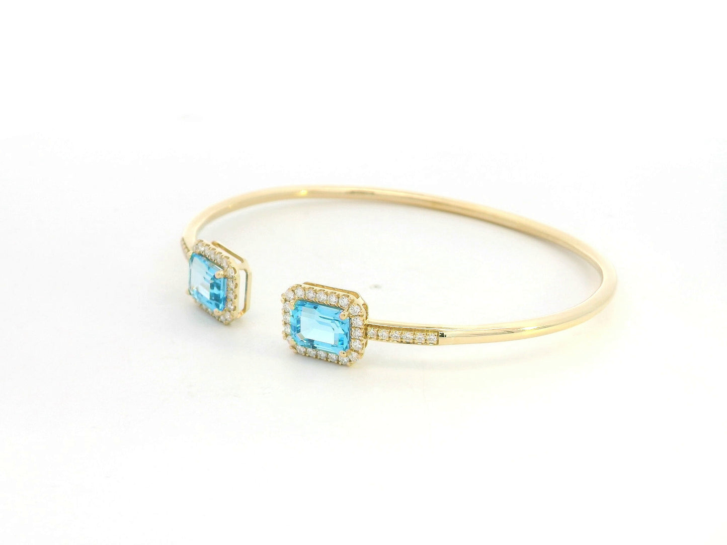 Blue topaz and diamond open cuff bangle bracelet in 18K yellow gold by Emirates Diamonds