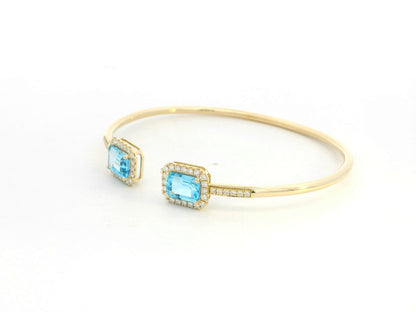Blue topaz and diamond open cuff bangle bracelet in 18K yellow gold by Emirates Diamonds