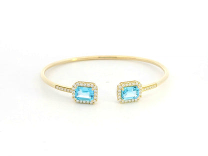 Blue topaz and diamond open cuff bangle bracelet in 18K yellow gold by Emirates Diamonds