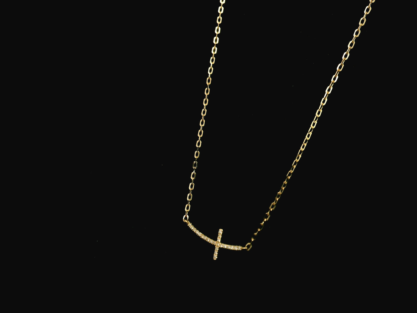 Diamond cross necklace in 18K yellow gold featuring 0.06 carats of diamonds by Emirates Diamonds.