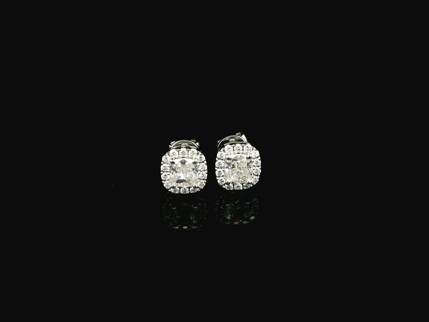 Cushion cut diamond halo stud earrings in 18K white gold with GIA certified diamonds by Emirates Diamonds