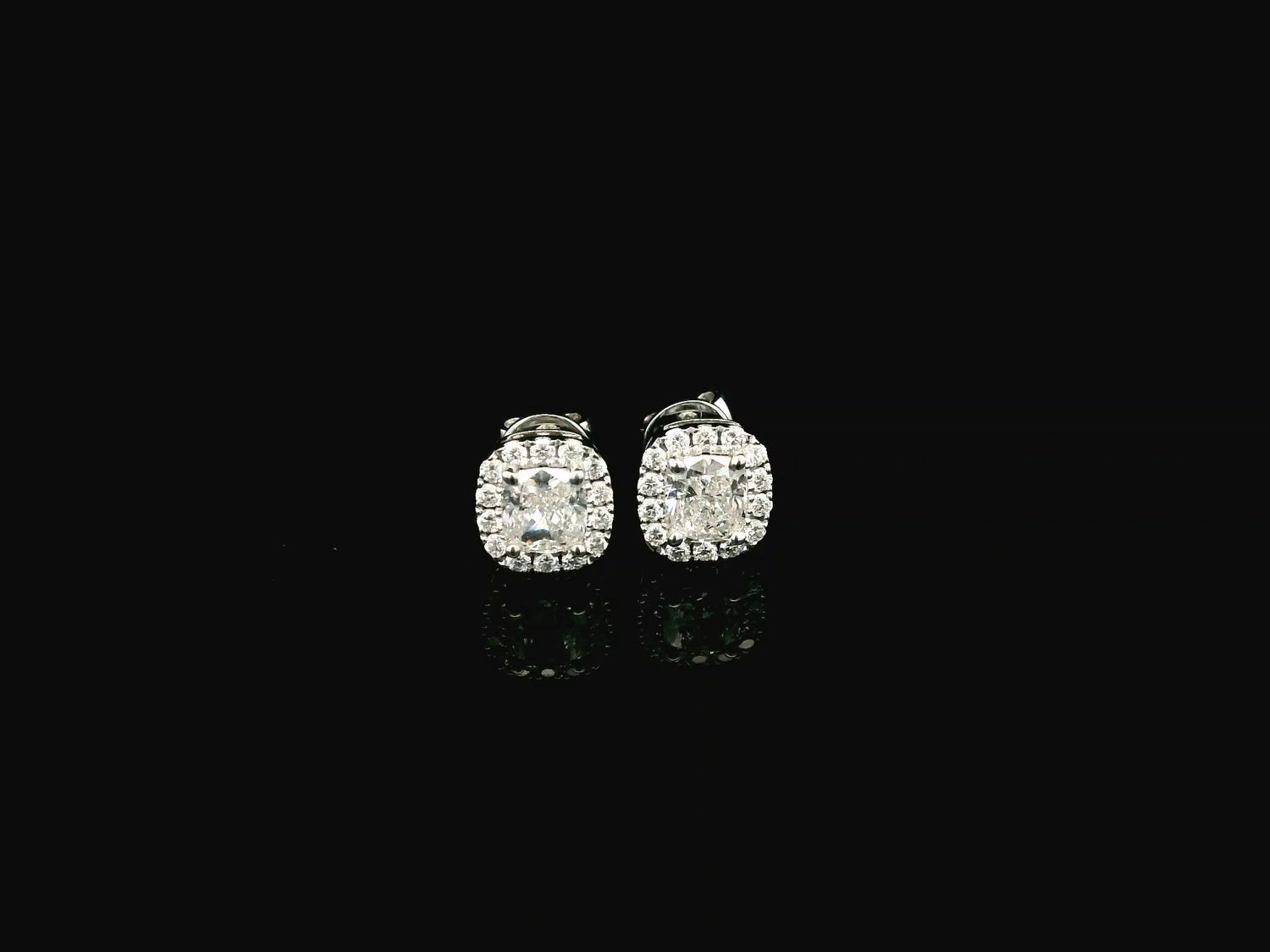 Cushion cut diamond halo stud earrings in 18K white gold with GIA certified diamonds by Emirates Diamonds