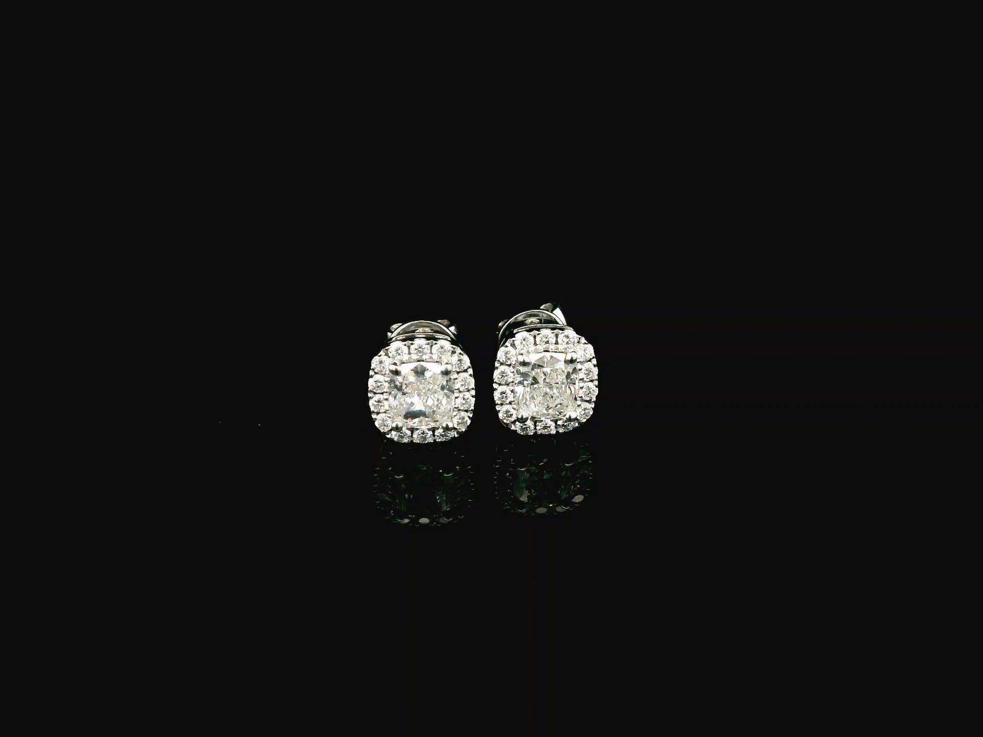 Cushion cut diamond halo stud earrings in 18K white gold with GIA certified diamonds by Emirates Diamonds