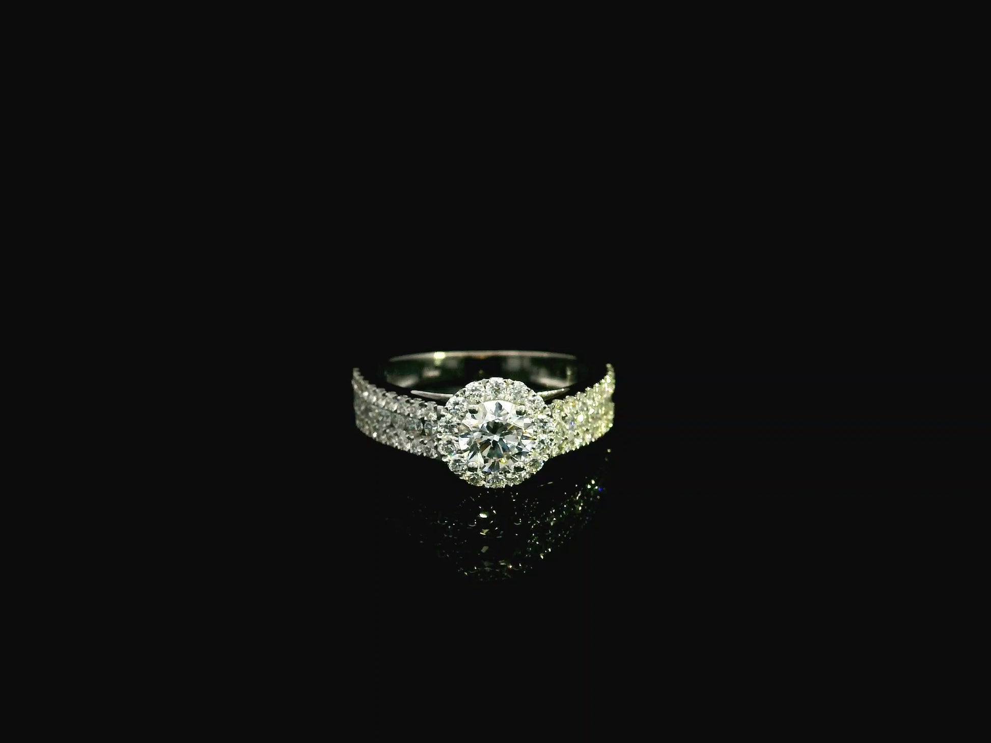 GIA certified 0.60 carat diamond halo engagement ring in 18K white gold with pavé diamond band by Emirates Diamonds
