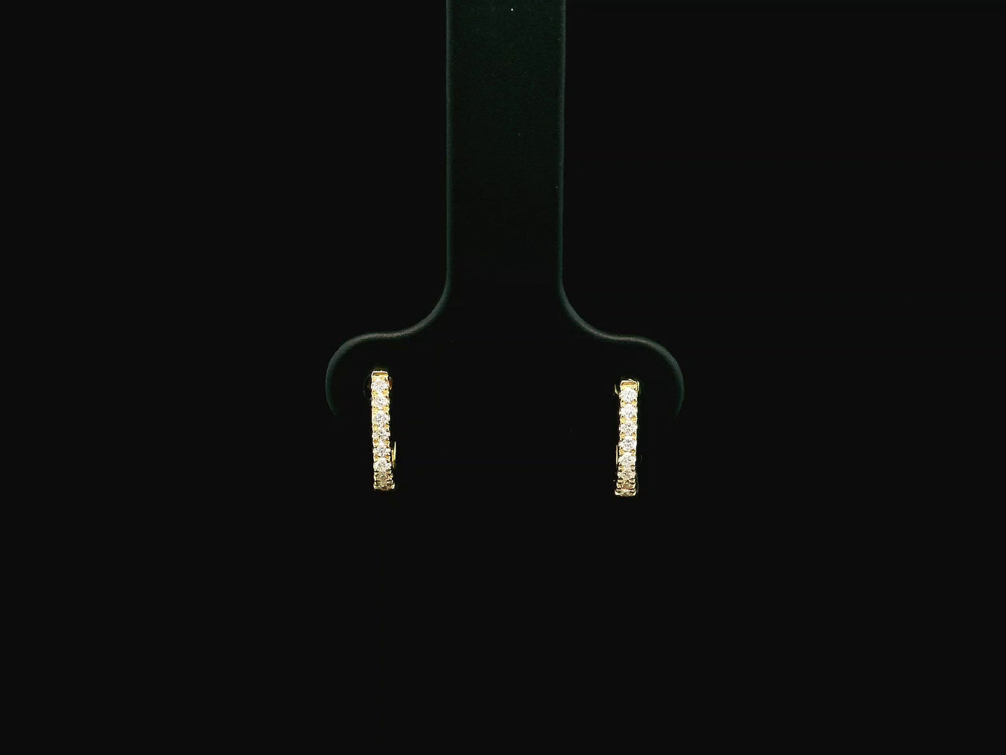 18K yellow gold diamond huggie hoop earrings featuring 0.09 carats of natural diamonds in a classic everyday hoop design.