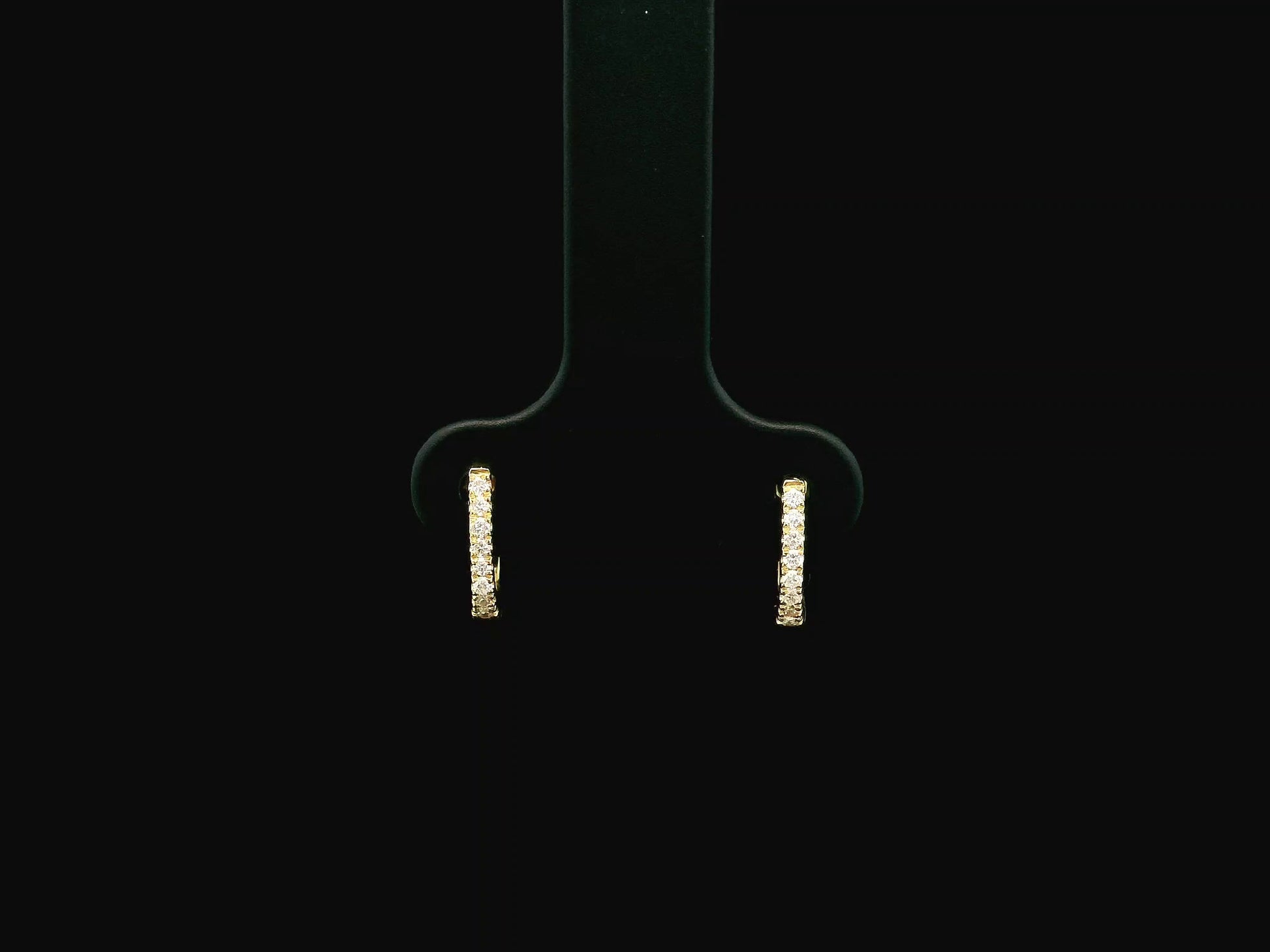 18K yellow gold diamond huggie hoop earrings featuring 0.09 carats of natural diamonds in a classic everyday hoop design.