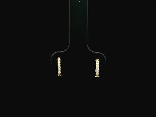 18K yellow gold diamond huggie hoop earrings featuring 0.09 carats of natural diamonds in a classic everyday hoop design.