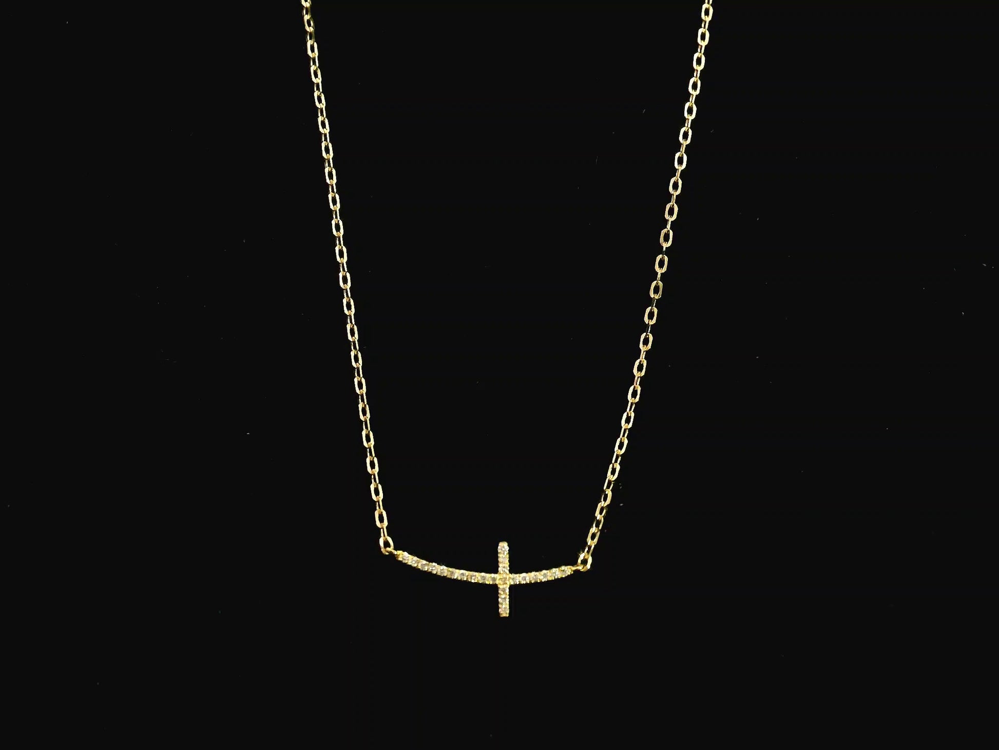 Diamond cross necklace in 18K yellow gold featuring 0.06 carats of diamonds by Emirates Diamonds.