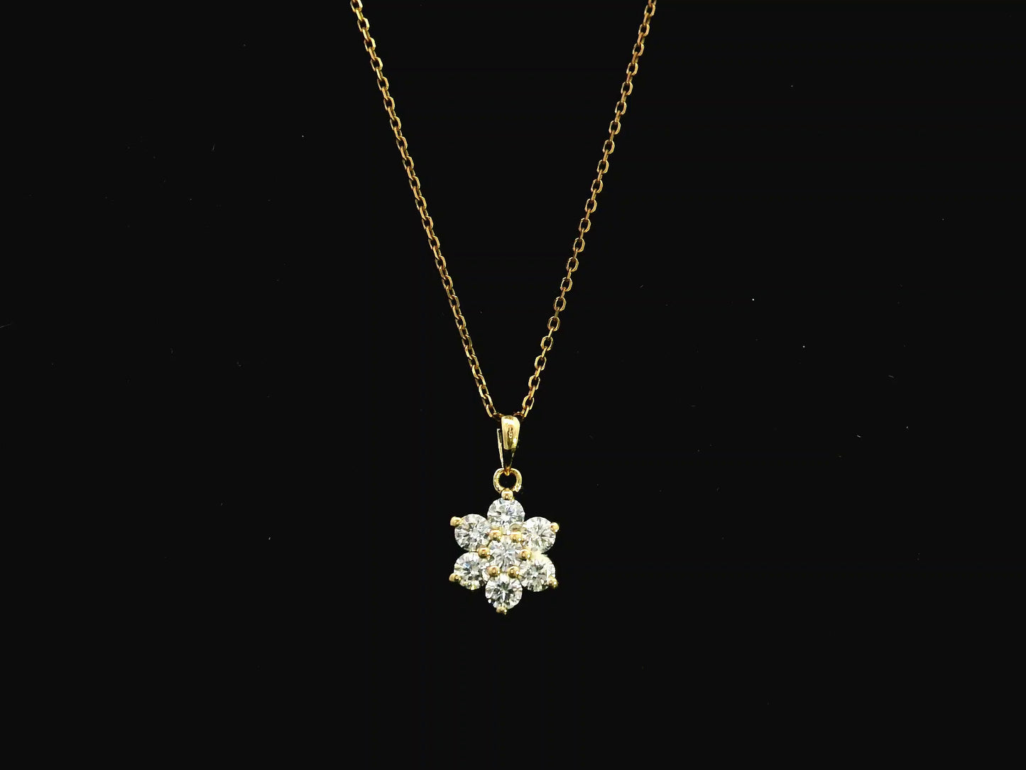 Diamond flower cluster pendant in 18K yellow gold featuring 0.55 carats of diamonds by Emirates Diamonds.