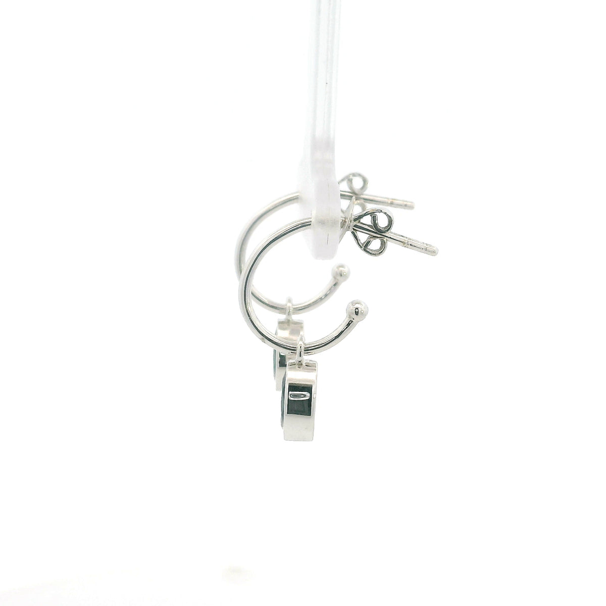 Oval blue sapphire drop hoop earrings in 18K white gold with polished hoops and suspended sapphire drops.