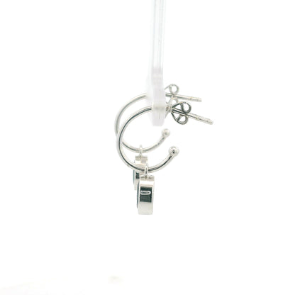 Oval blue sapphire drop hoop earrings in 18K white gold with polished hoops and suspended sapphire drops.