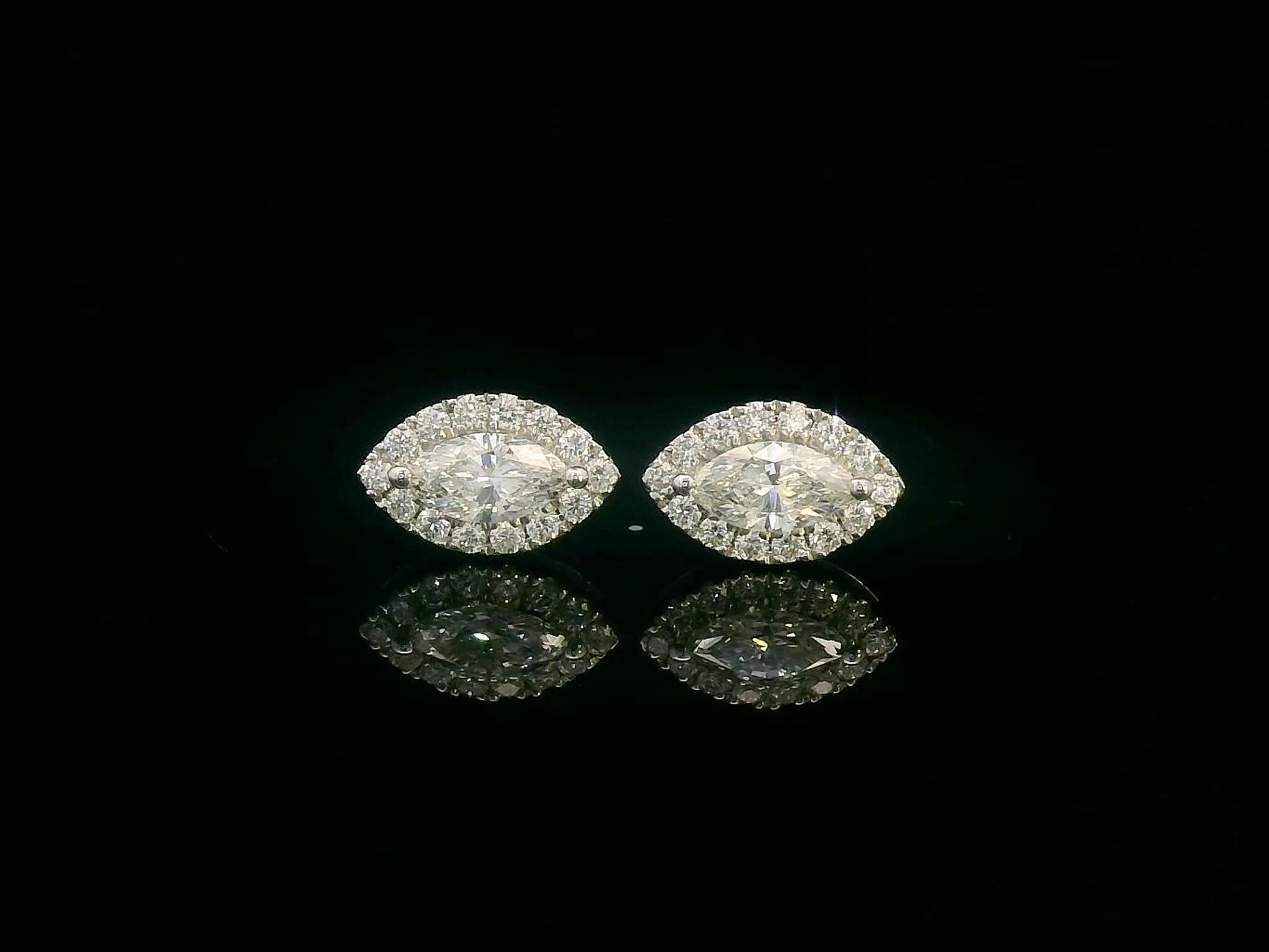 18K gold marquise diamond halo stud earrings with round-cut diamond accents – 0.69 carat total weight

