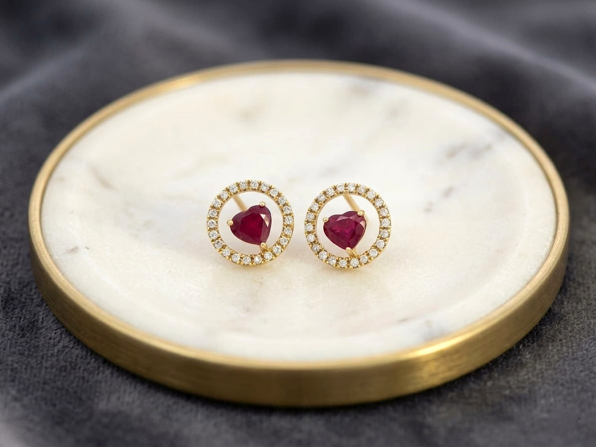 Heart shaped ruby and diamond halo stud earrings in 18K yellow gold by Emirates Diamonds