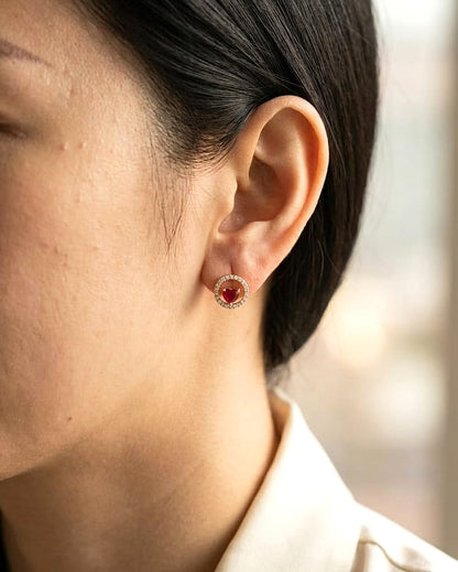 Heart shaped ruby and diamond halo stud earrings in 18K yellow gold by Emirates Diamonds