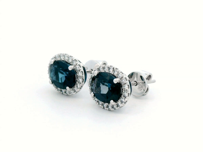 Oval London Blue Topaz & Diamond Halo Stud Earrings In 18k Gold.