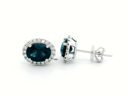 Oval London Blue Topaz & Diamond Halo Stud Earrings In 18k Gold.