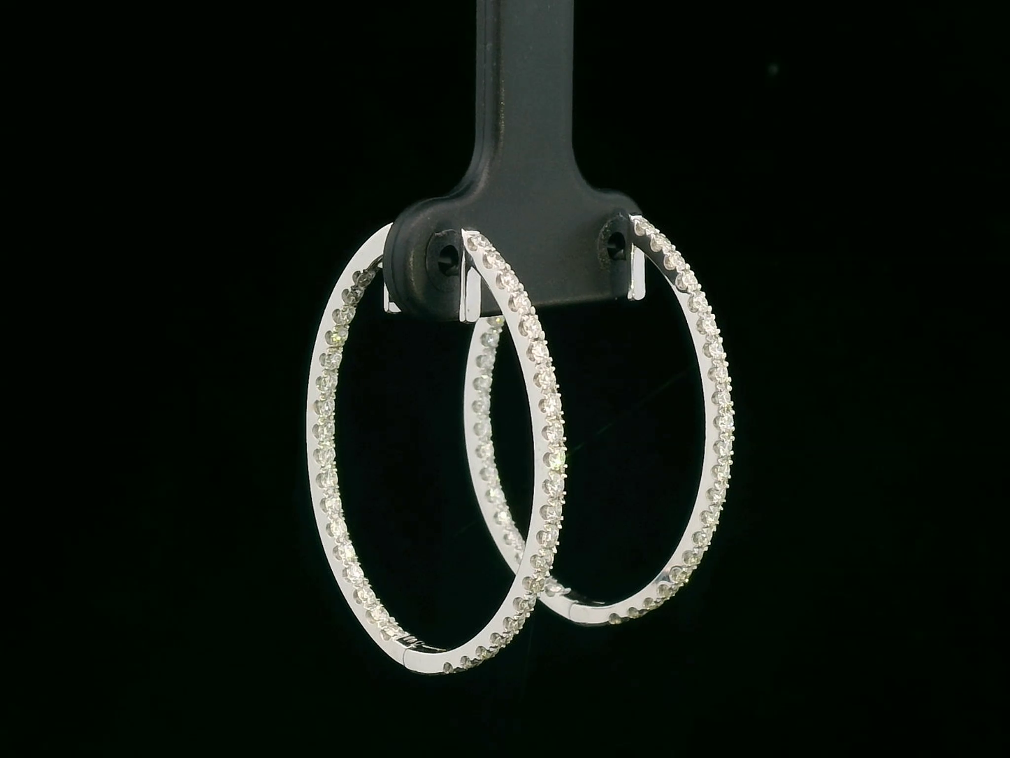 18K gold diamond hoop earrings featuring 0.97 carats of round-cut diamonds in an elegant design.