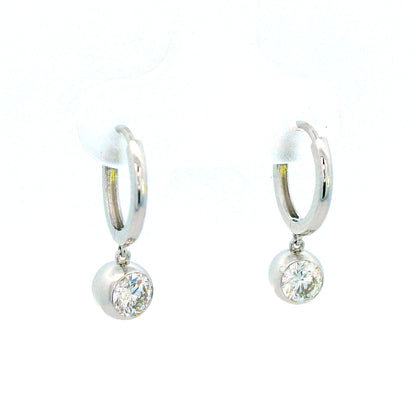 18K gold dangle hoop earrings with 0.57 carats bezel-set diamonds.