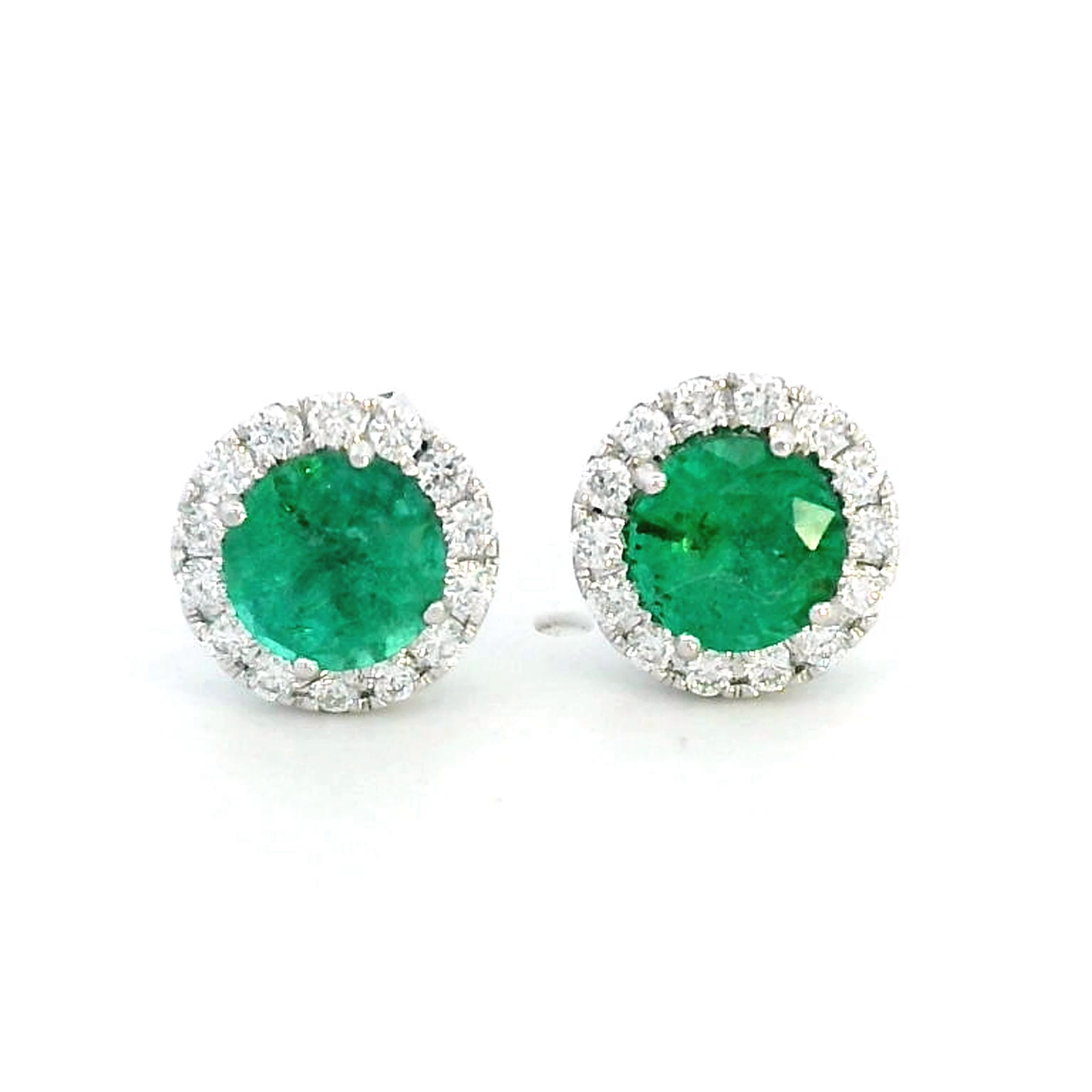 A pair of elegant 18K gold earrings featuring 1.11 carats of round-cut emeralds surrounded by a 0.25-carat halo of sparkling round diamonds, with push-back closures.