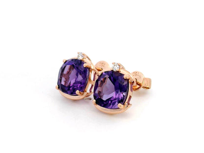 18K gold cushion-cut amethyst stud earrings featuring vibrant 3.99-carat amethysts with diamond accents totaling 0.05 carat.